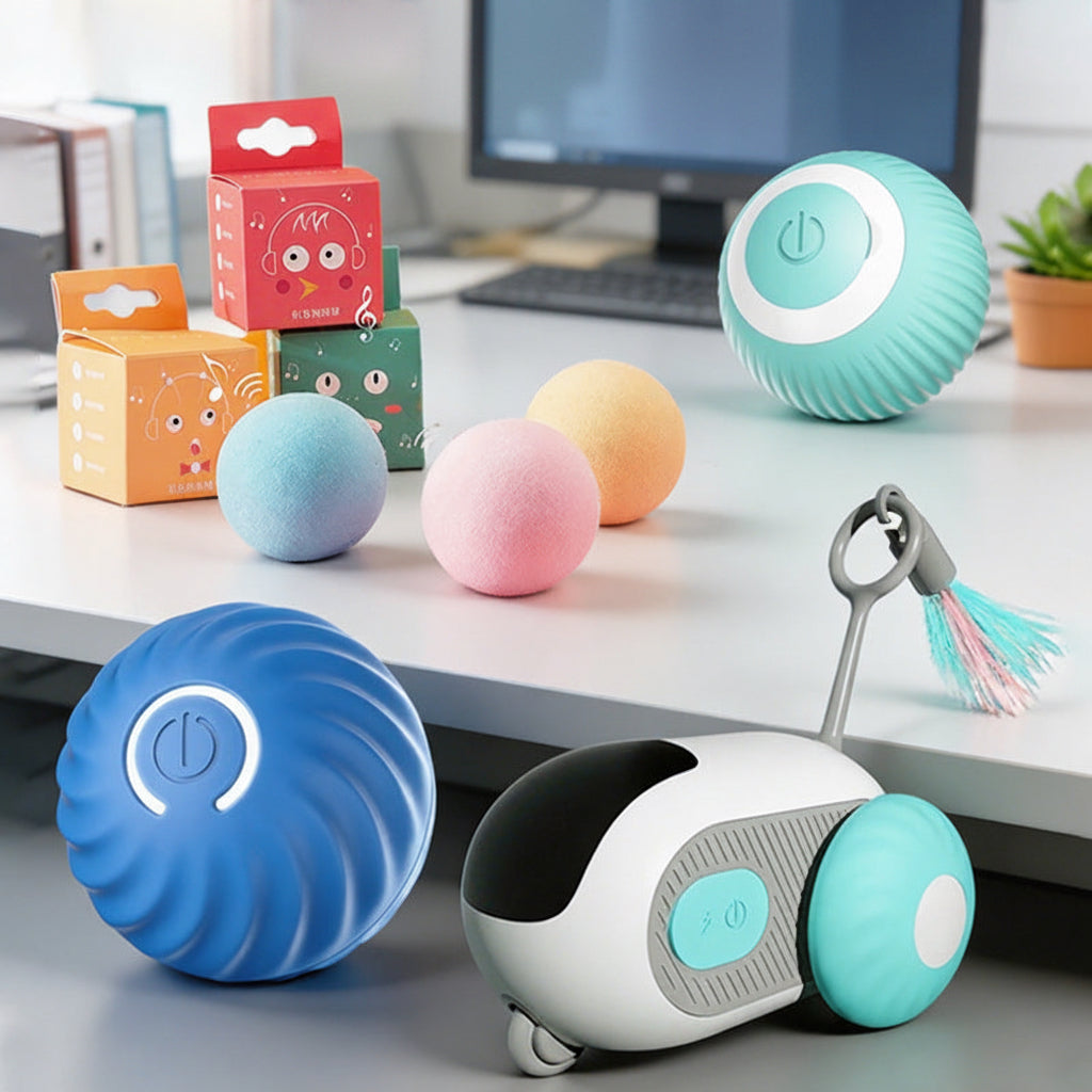 Colorful cat toys on a desk with a computer monitor in the background
