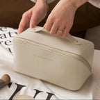Beige cosmetic bag with 'Rose of No Man's Land' branding on a white surface with text.