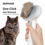 Pet grooming brush with collected fur next to a gray cat, featuring the brand 'aumuca'.